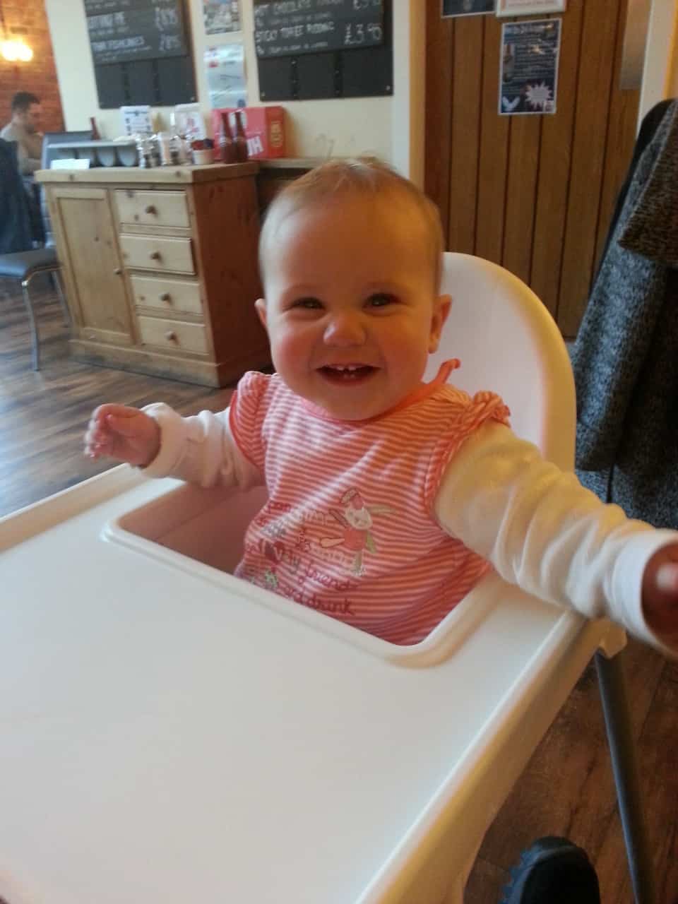 Happy baby in high chair