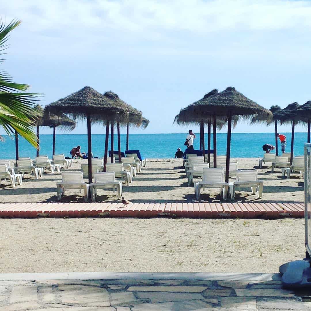 parasols and sun loungers on burriana beach nerja 