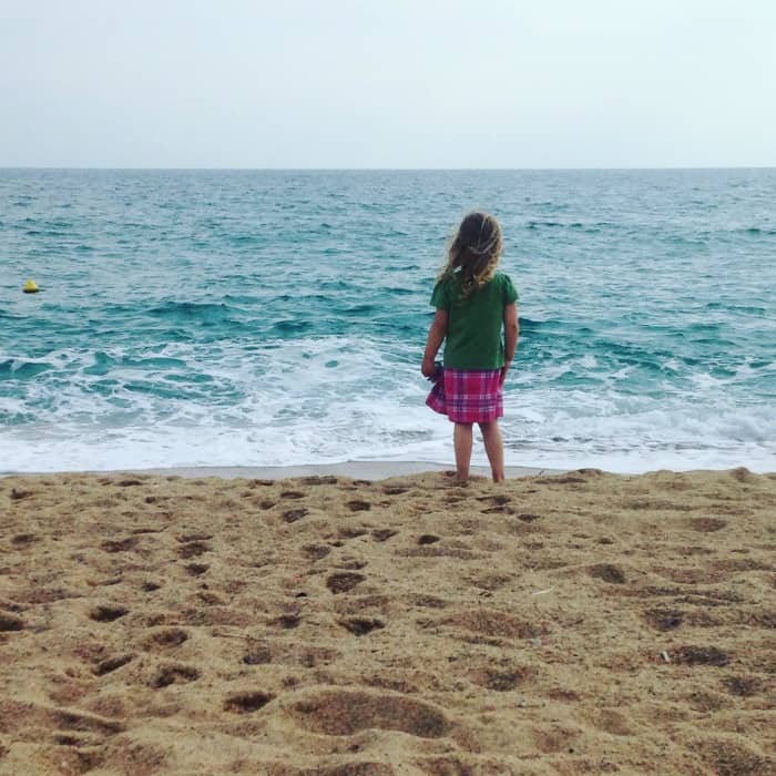 child looking at the sea