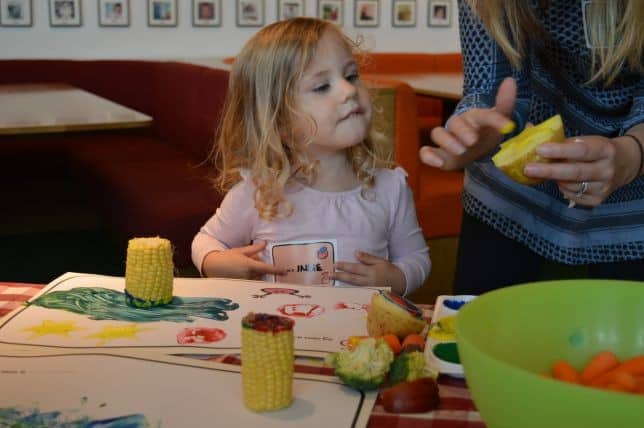 child doing printing with vegetables