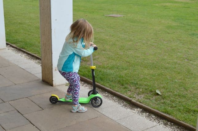 child on scooter