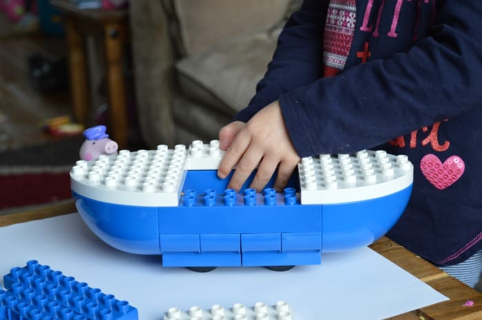 girl making peppa pig boat