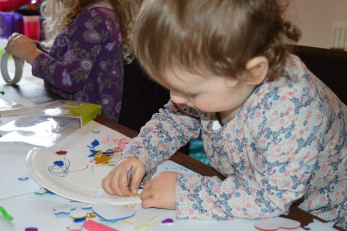 toddler doing valentines day love bugs craft