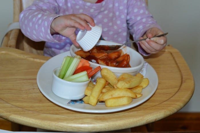 child eating pasta