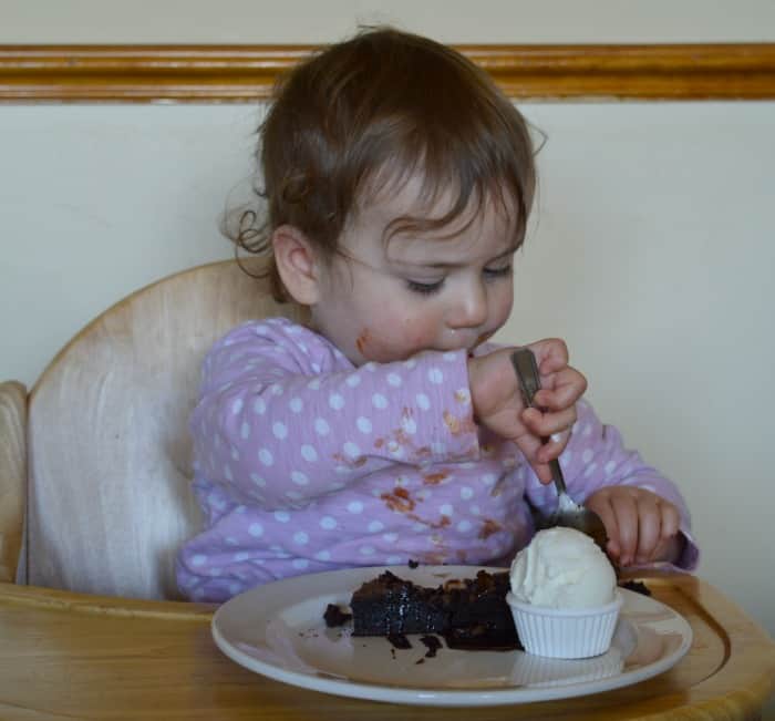 child eating pudding