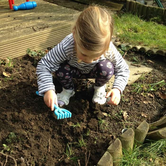 child digging in the garden