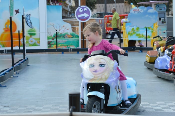 child on frozen bike at fair