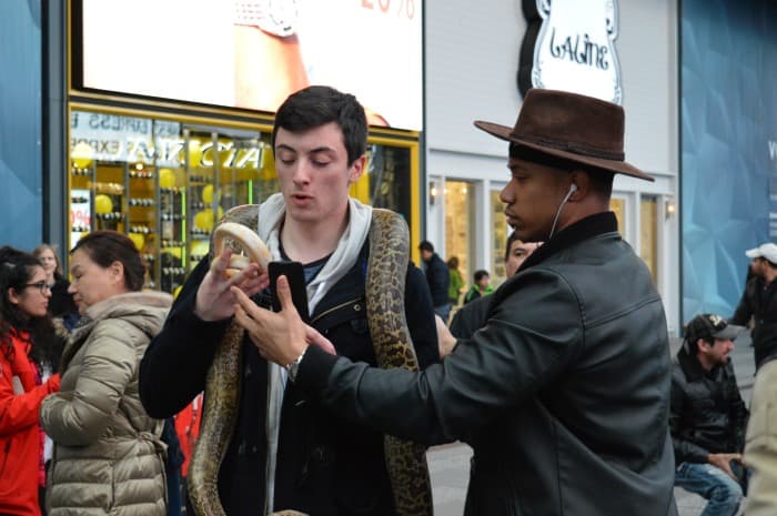 teen catching a snake in his hand