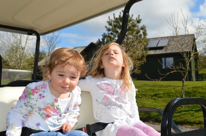 children riding golf buggy