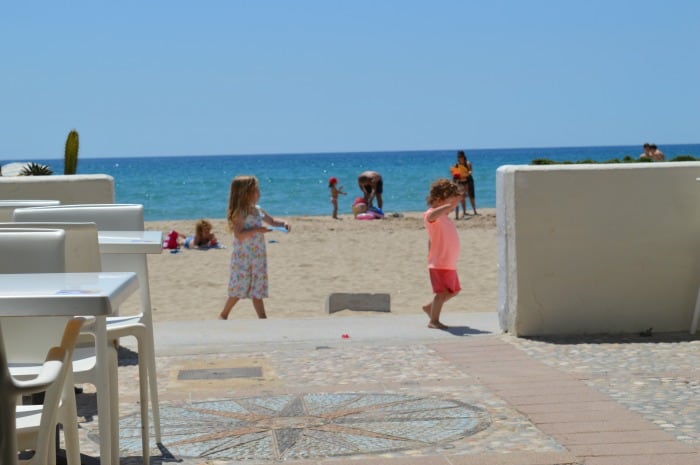 kids on beach near cafe