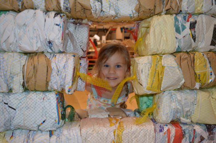 child looking through a hole in a wall