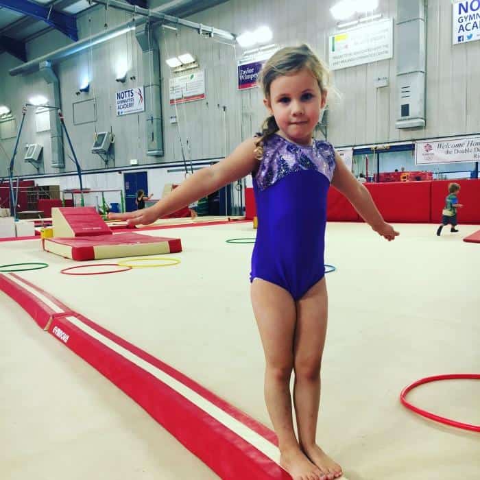 girl-practising-beam-at-gymnastics
