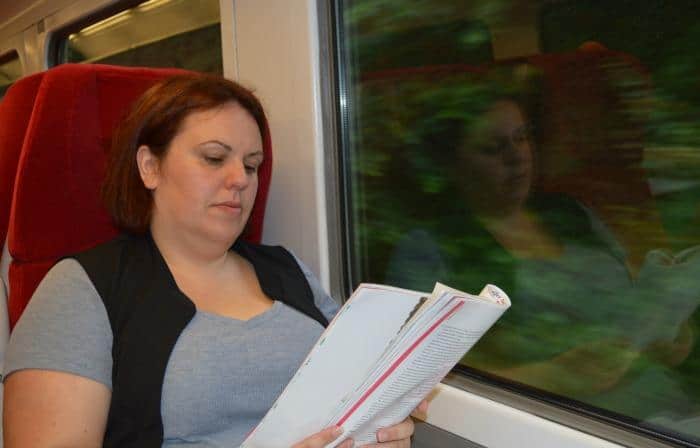 reading a magazine on a train