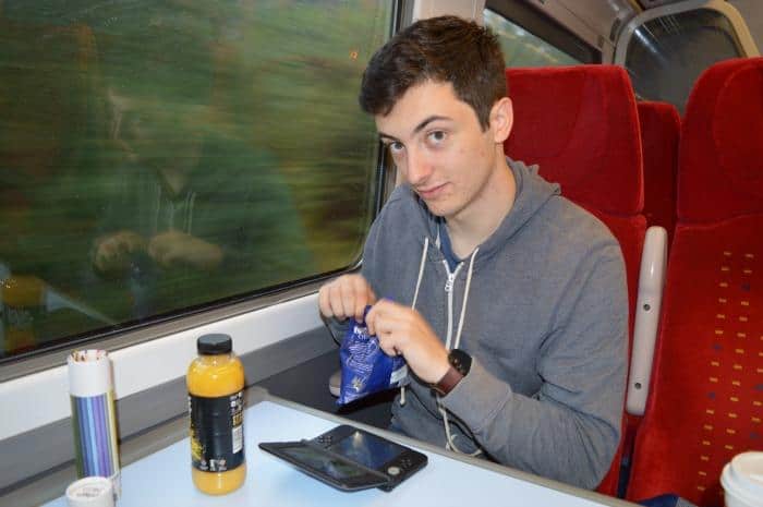 teenager on train to Manchester eating snacks