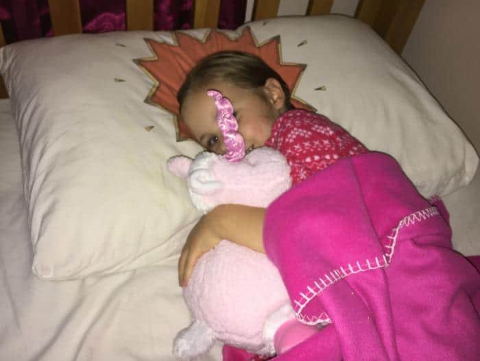 child-sleeping-with-toy-unicorn