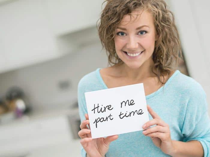 Casual woman holding a small banner at home and looking at the camera smiling