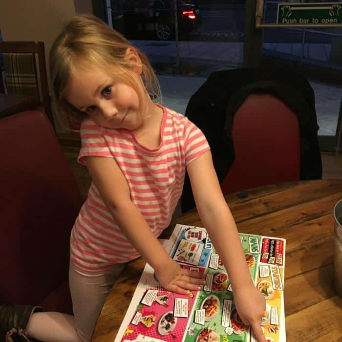 child-choosing-from-menu-at-brewers-fayre