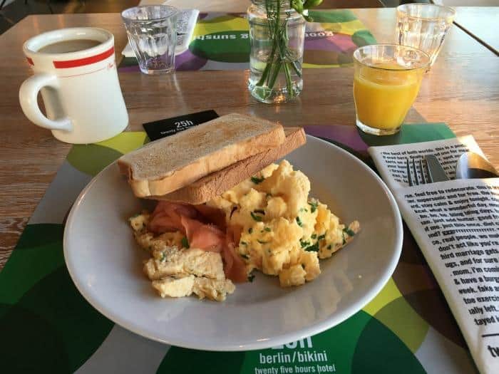 plate of smoked salmon, scrambled eggs and toast with coffee and juice at 25h hotel berlin