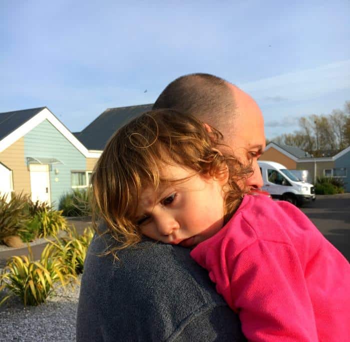 tired child on daddy's shoulders