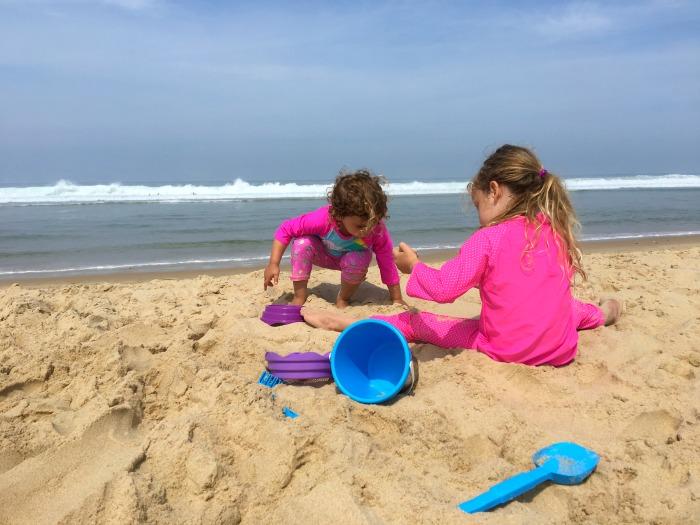 girls playing on beach on holiday 