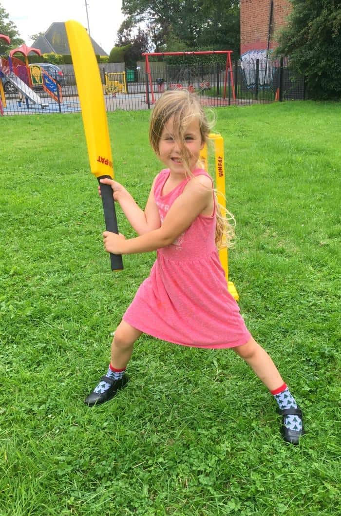 girl playing cricket