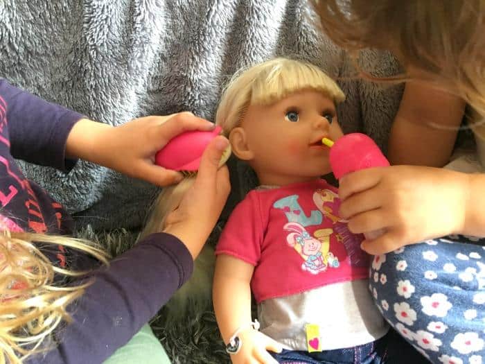 playing with sister doll
