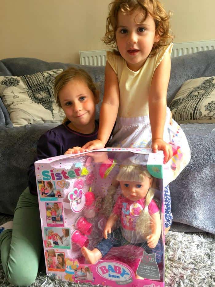 sisters with doll