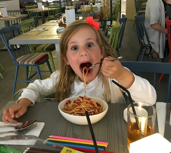 child eating spaghetti