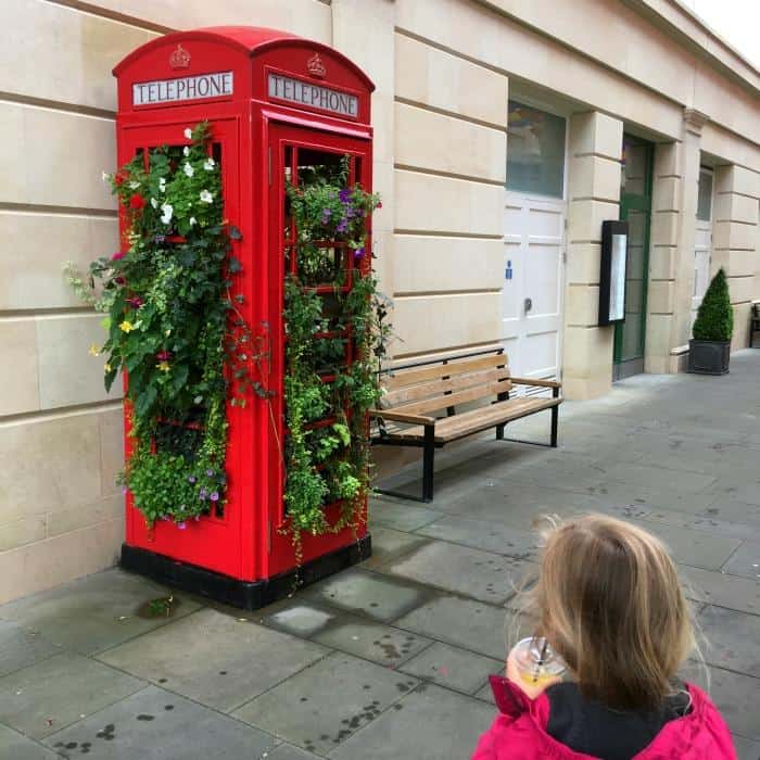 red telephone box turned into a garden on street in bath england