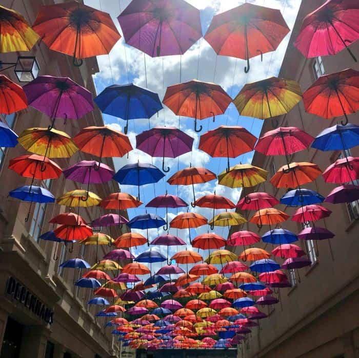 street display of colourful umbrellas in Bath England 