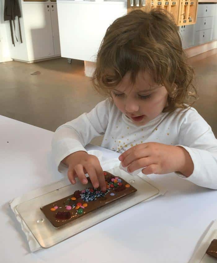 child decorating chocolate bar