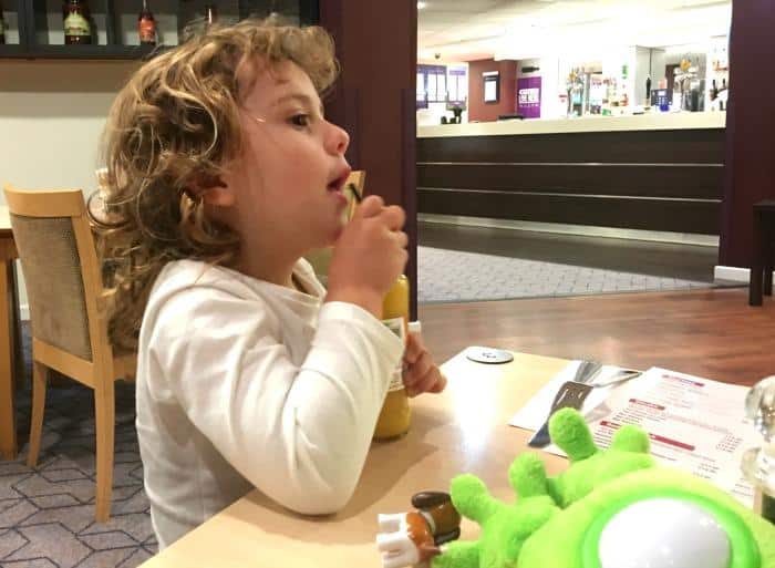 child having a drink in a restaurant