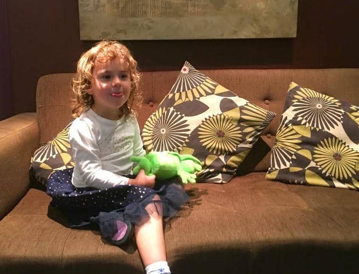 3 year old child sitting on sofa at hotel 