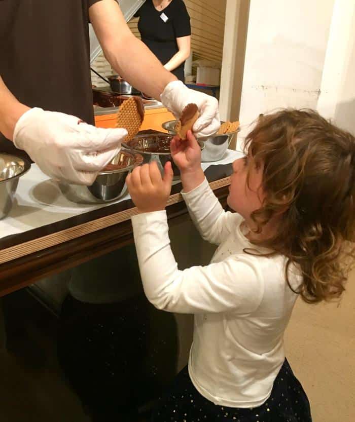 child tasting chocolate