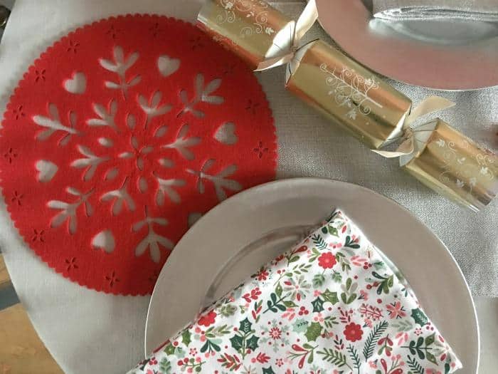 silver and red christmas place setting