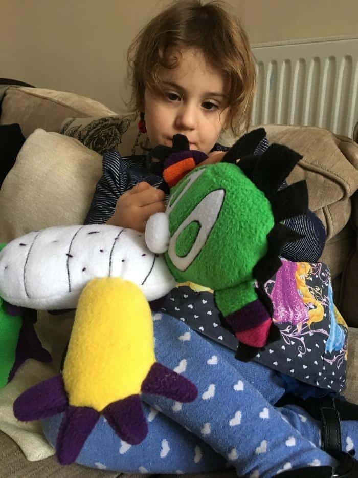 child sitting with dragon toy