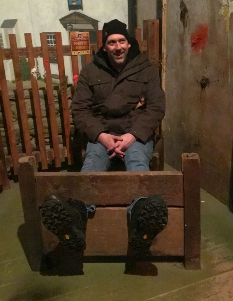 man sat in stocks at pirates quest newquay 