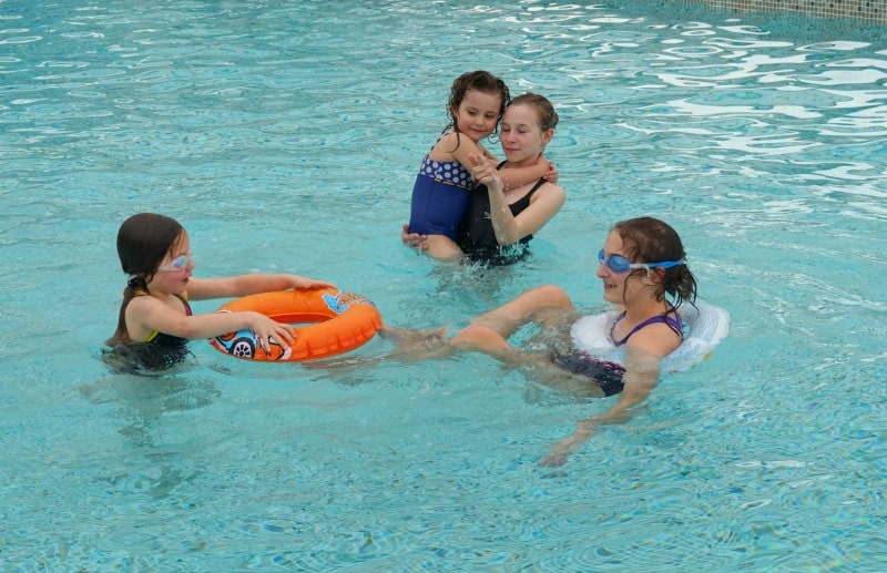 children swimming in the pool on holiday 