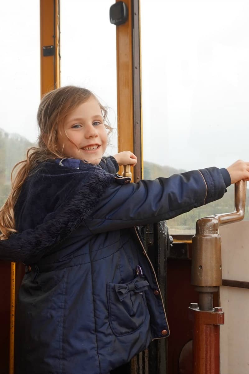 Child pretending to drive a tram - seaton tramway devon 