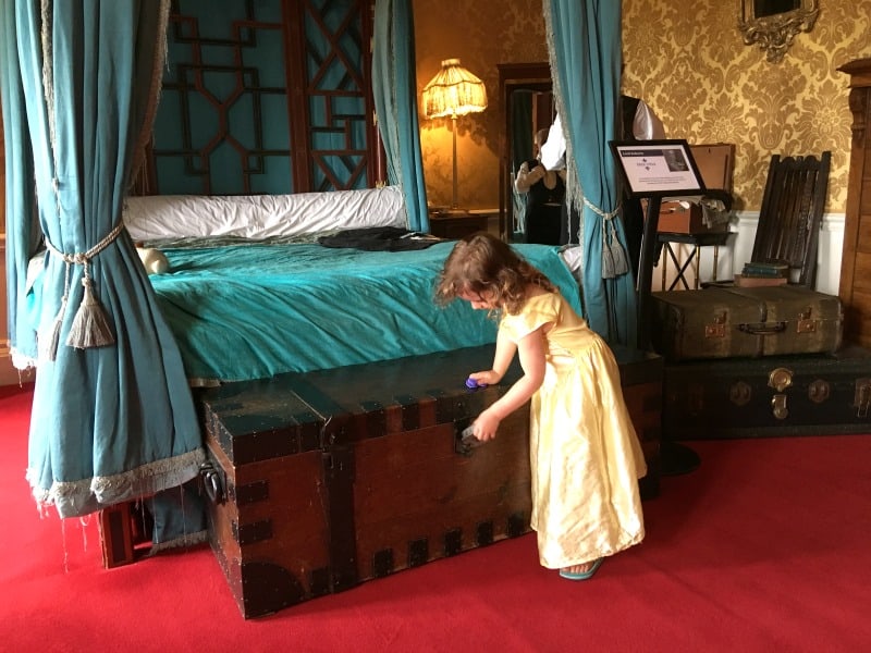 sample bedroom with four poster bed and wooden chest inside warwick castle