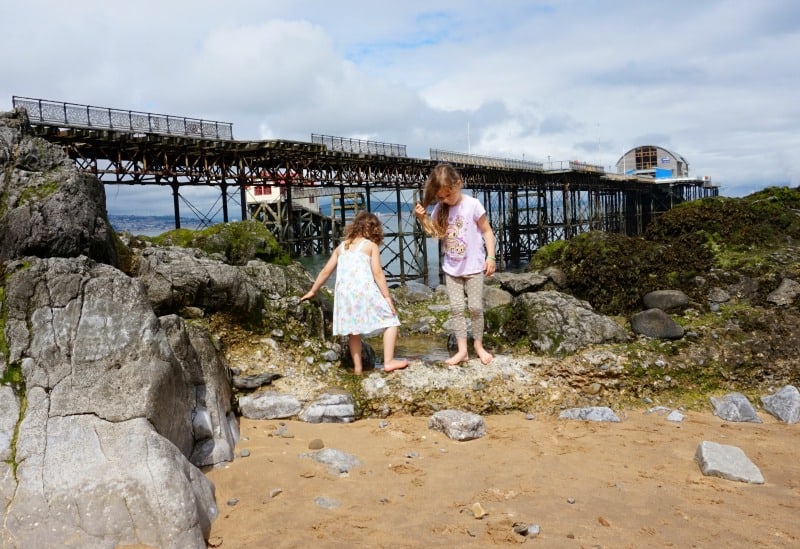 kids playing on beach at mumbles pier swansea bay