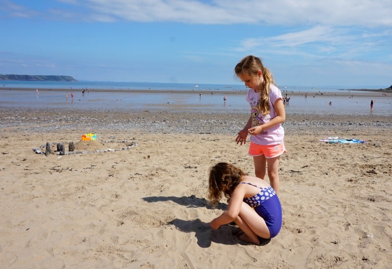 children playing on oxwich bay beach near swansea wales