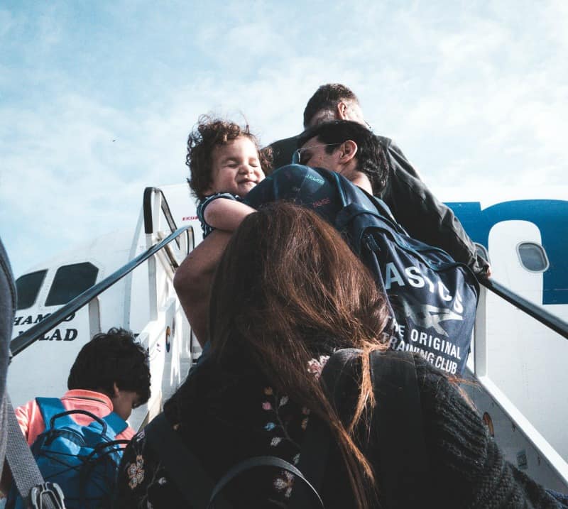 family getting on a plane