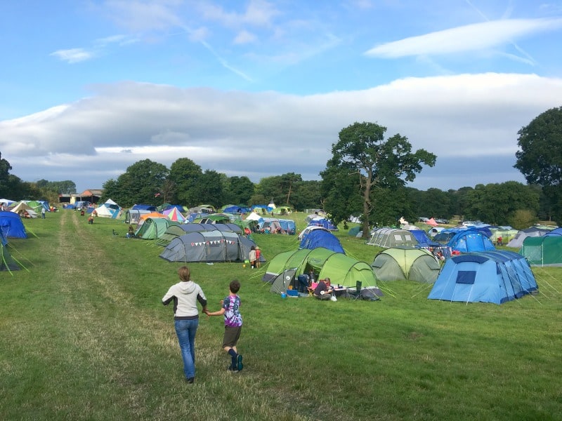 tents in festival camping field featuring families 