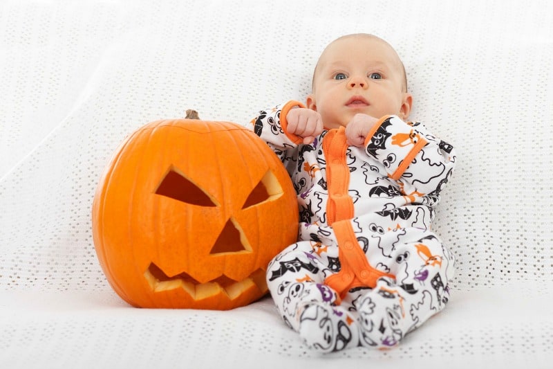 baby in halloween outfit with pumkin