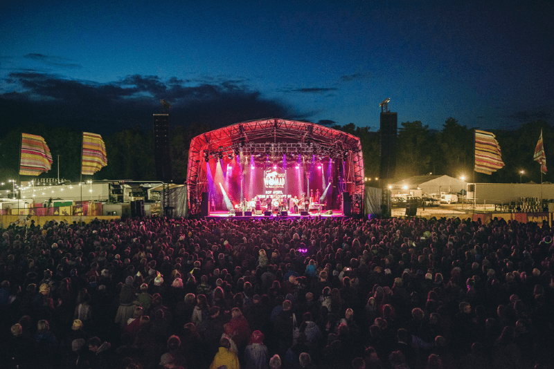 music stage at night in front of festival crowd at womad festival