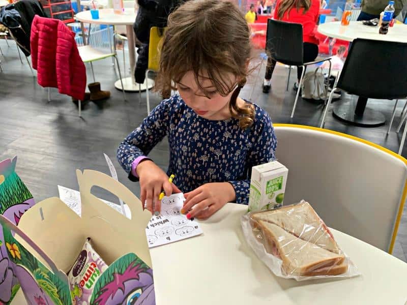 child with colouring and kids lunch box at red kangaroo