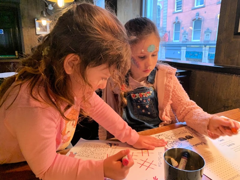 two kids colouring at table at Red Dog Saloon