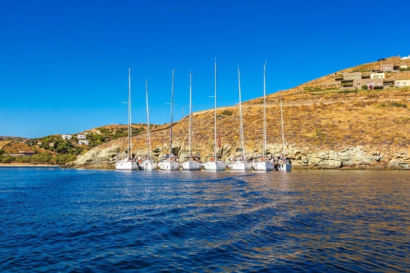row of sailing boats in Mediterranean sea near Cyclades Greece
