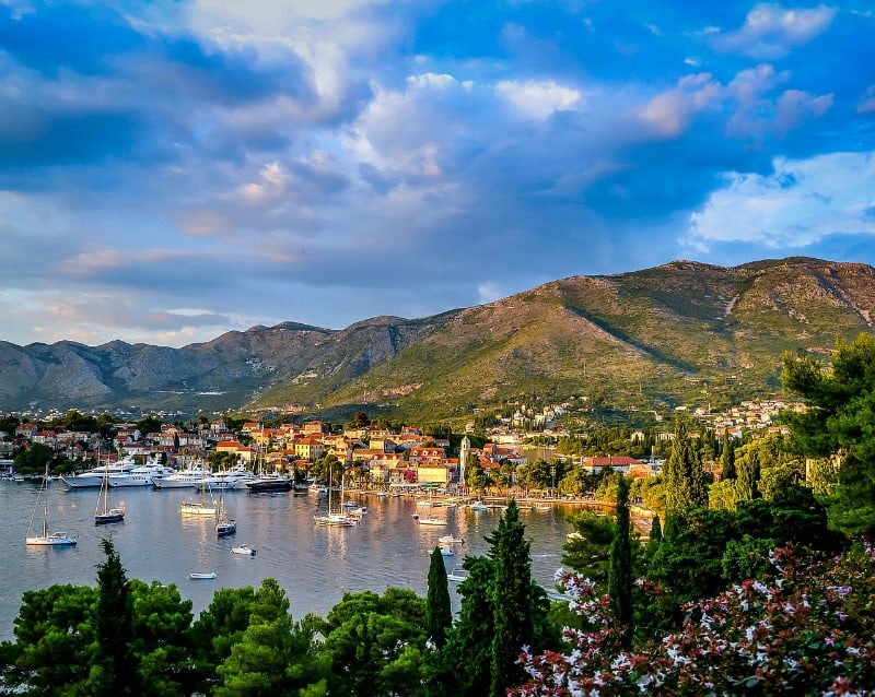 variety of yachts and sailing boats in harbour with views of Mountains in Croatia